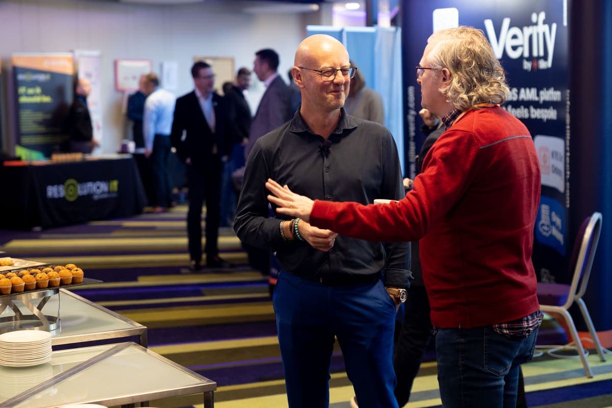 Andy Jarvis networking with an attendee at a conference