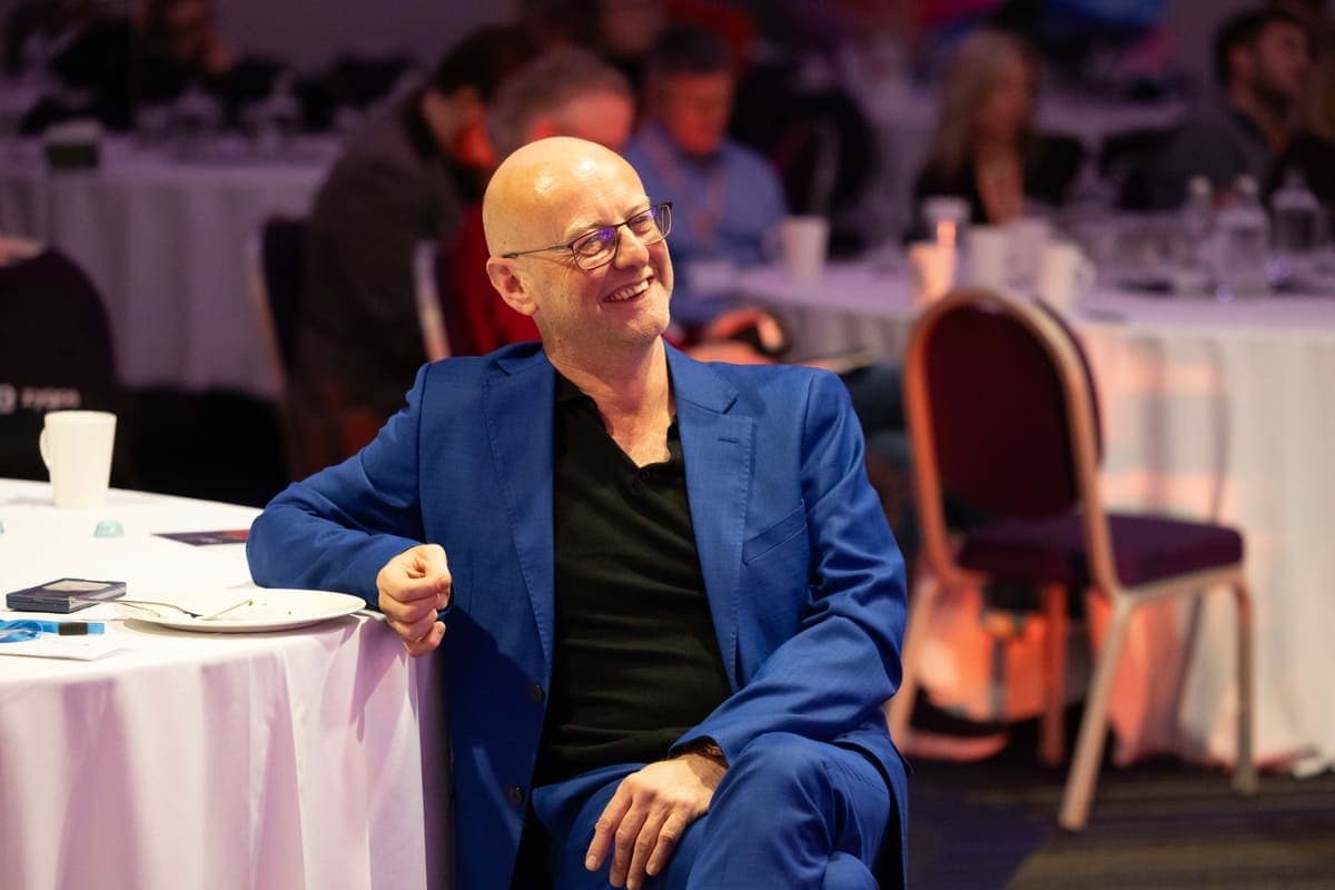 Andy Jarvis smiling at a roundtable